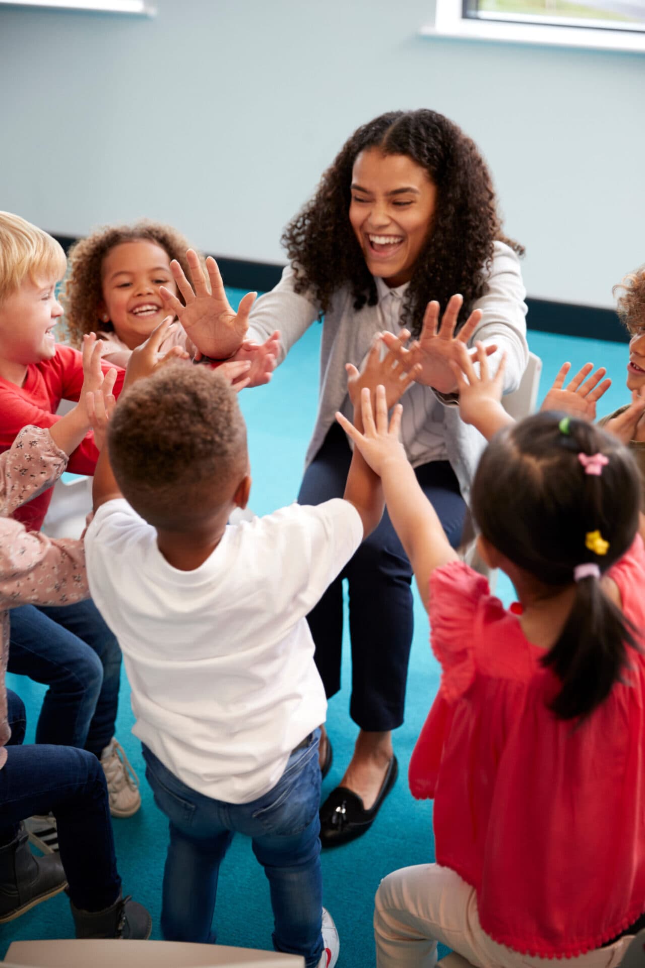 A Creation Kingdom teacher reading with children